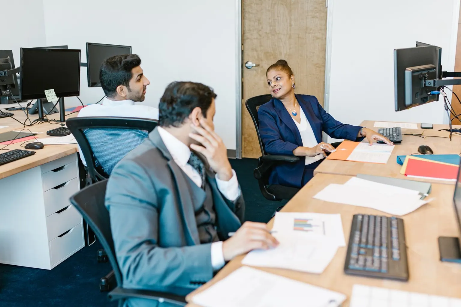 Business professionals collaborating in a modern office setting. Ideal for workplace concepts.