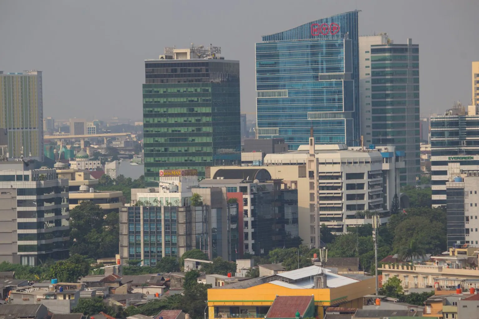 Aerial view of Jakarta's urban skyline showcasing modern skyscrapers and bustling city life.